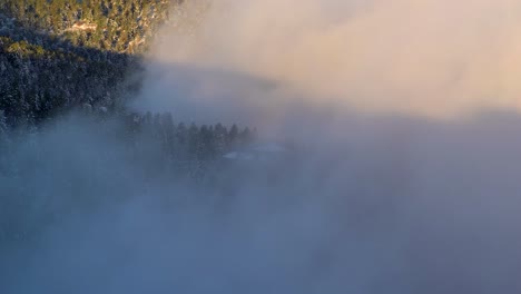 cloud flowing over the foothill of mountain