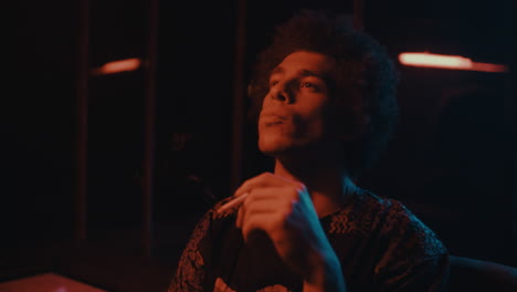 man smoking in a nightclub