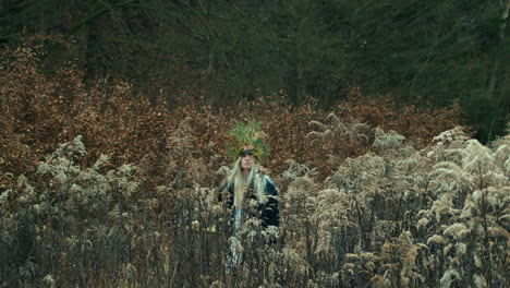 Queen-of-nature-walking-through-branches-with-skull-on-wooden-stick