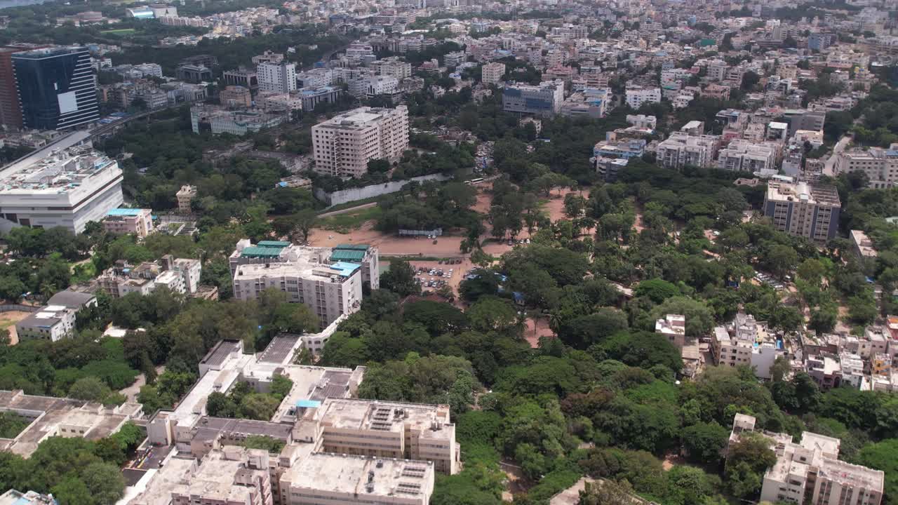 Aerial footage of India's urban residential and commercial centres in Hyderabad, Telangana a house, a terrace, hotels, and some trees are shown