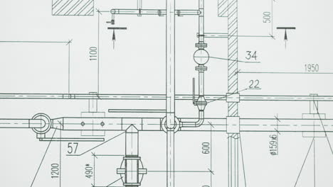 close-up of engineering blueprint with pipe systems and measurements