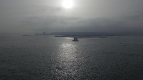 Cinematic-drone-shot-over-the-ocean-towards-the-beach