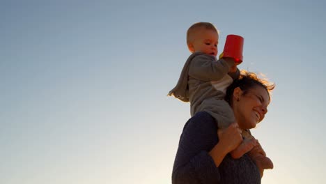 Mother-playing-with-her-baby-boy-in-the-beach-4k