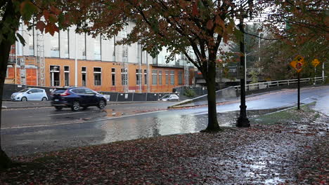 Slow-Motion-of-cars-driving-through-a-puddle-of-water-in-Portland,-Oregon-USA-in-high-resolution-HD