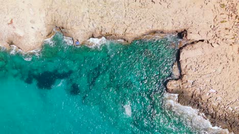 aerial view looking down on sea caves at cavo greko in cyprus