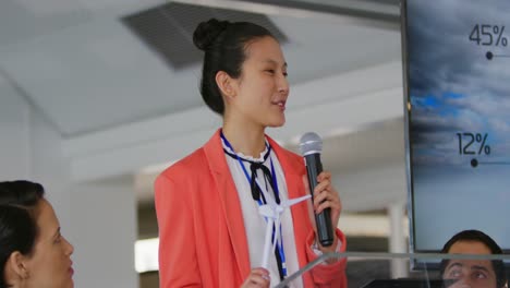 Female-speaker-addressing-the-audience-at-a-business-conference