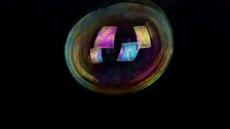 large soap bubble isolated on black background slow motion