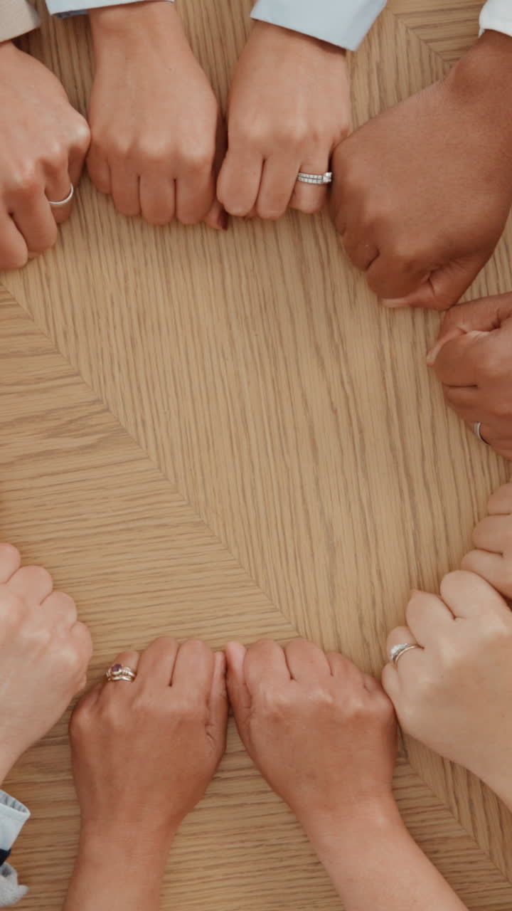 People's Hands Forming a Circle on a Wooden Table