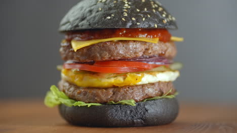 turkey black burger with mushrooms and mushroom sauce on black stone tray