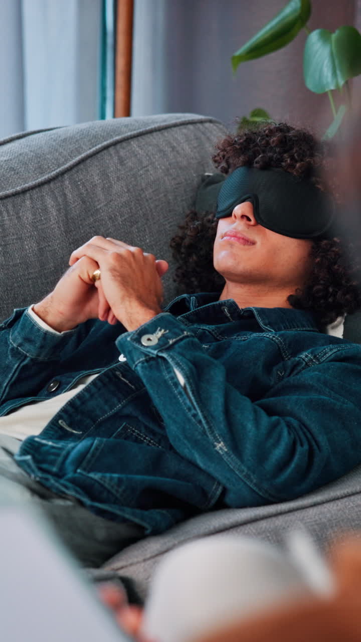 Person wearing a sleep mask on a couch