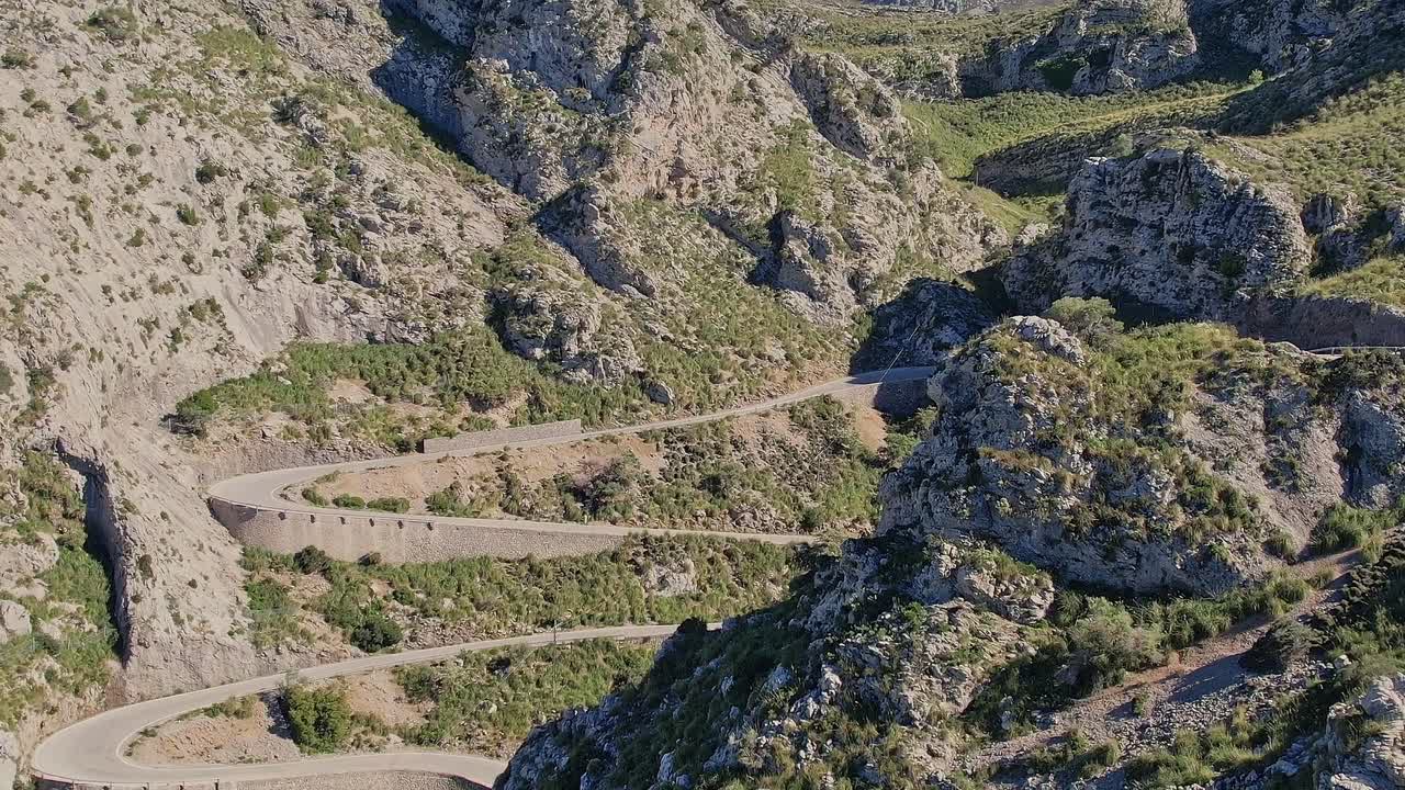 Winding road through rocky landscape in Mallorca, Spain from above