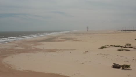 Aerial:-A-beach-with-a-windturbine-park-in-the-distance-in-Brazil