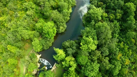 aerial view of the trees, forests and river in the derbyshire peak district national park near bakewell, commonly used by cyclists, hikers, popular with tourists and holiday makers