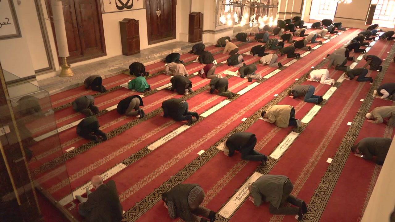 Bir camide namaz kılan bir grup erkek.