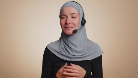 Muslim-woman-wearing-headset,-freelance-worker,-call-center-or-support-service-operator-helpline