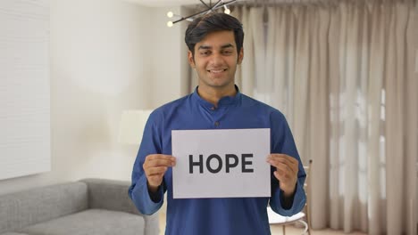 Happy-Indian-boy-holding-HOPE-banner