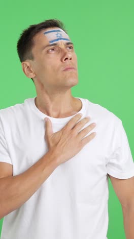Man listening to the Israel national anthem with solemnity