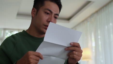 sad man reading letter