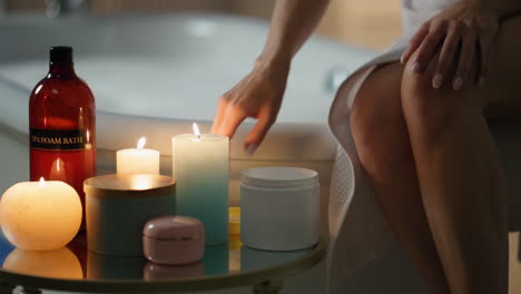 girl moisturizing hands evening room closeup. relaxed woman applying skin cream