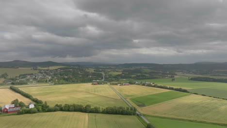 Rural-countryside-in-Norway-with-farm-plots-on-cloudy-day,-aerial