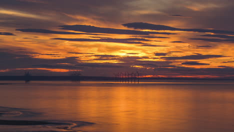 Redcar-Wind-Farm-Time-Lapse,-towards-South-Gare,-River-Tees-entrance,-golden-summer-setting-sun