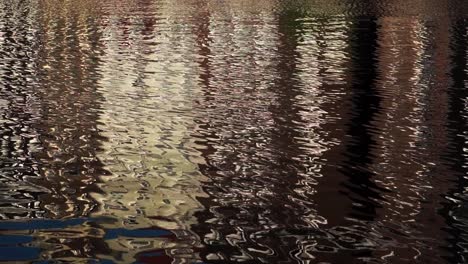 row houses in amsterdam being reflected in canal waters