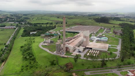 aerial view of industry plant chimney, industrial area in the middle of green area, the glass production