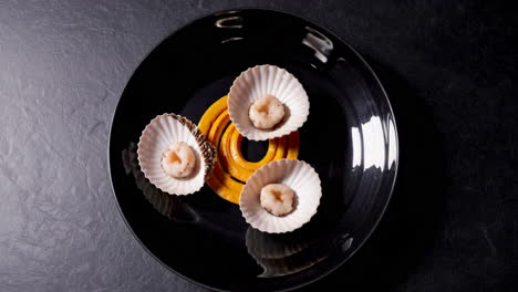 gourmet seafood appetizer on black plate