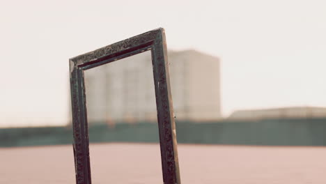 empty wooden picture frame on the beach sand