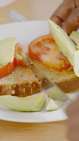 cutting avocado and tomato toast