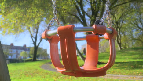 empty playground swing with slow move in