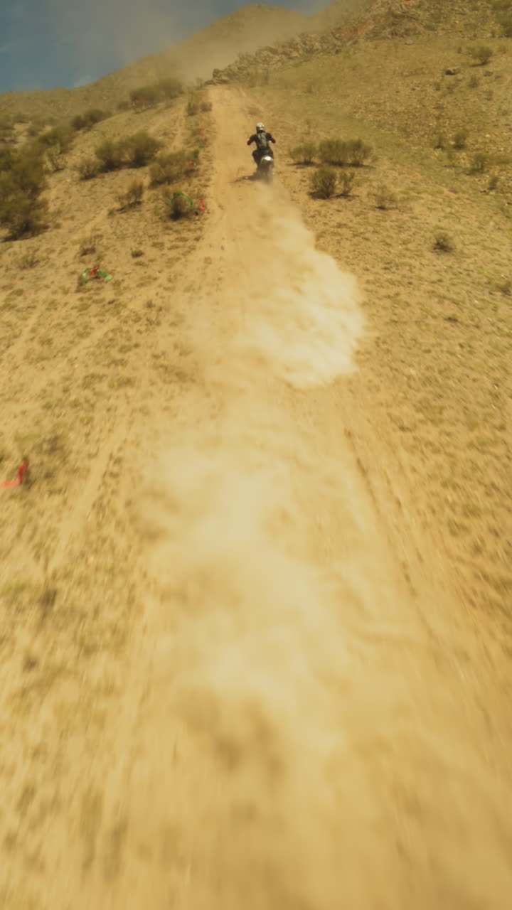 Motorcyclist journey up slope fpv drone. Vivid illustration of passion and perseverance defining essence of extreme sport training. Commitment to excellence