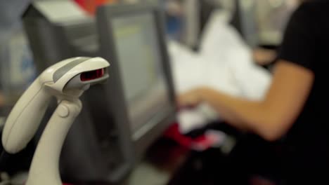 woman cashier scans barcode on