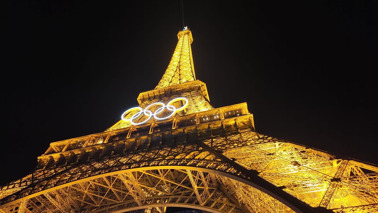 Eiffel Tower Olympic rings Paris France touristic landmark at night light up