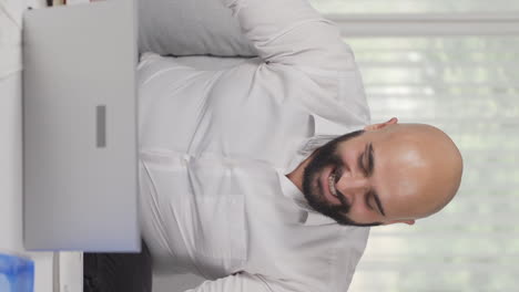 vertical video of home office worker man happy and cheerful.
