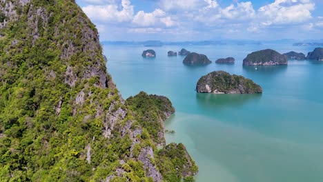 drone footage captures lush islands and turquoise waters of phang nga bay, thailand, under bright daylight, showcasing natural beauty and tranquility