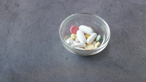 assorted pills in a glass bowl