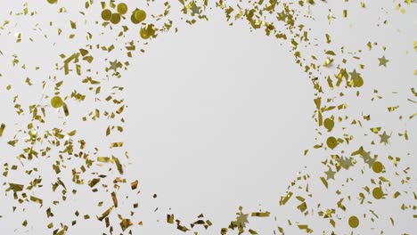 Video-of-gold-confetti-on-white-background-with-central-round-copy-space