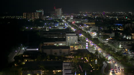 Aerial-view-of-Cancun-city-at-night-with-cars-driving-by-on-Av