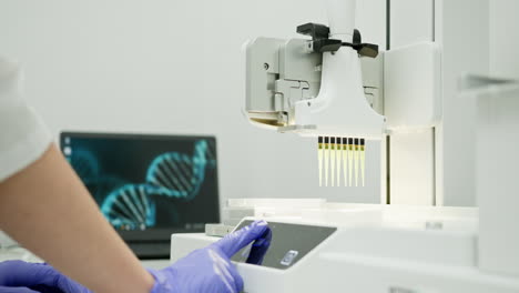 scientist using automated dna sequencing machine