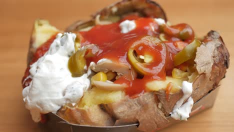 stuffed baked potato with tomato sauce and yogurt