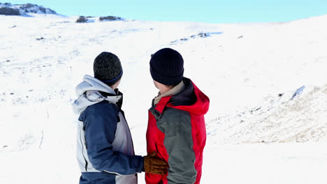 Active-couple-embracing-each-other-and-admiring-the-scenery