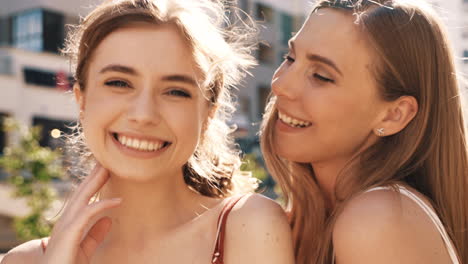 two happy women friends outdoors in the city