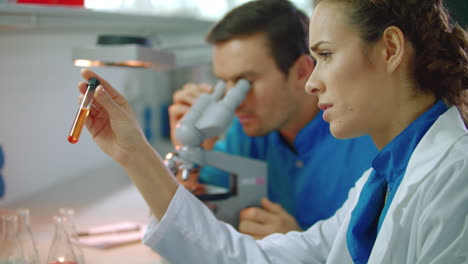 Science-researchers-team-doing-lab-research.-Scientist-research-on-tablet-pc