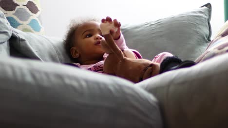 Close-up-of-baby-watching-tv-on-the-couch