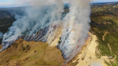 High-aerial-view-of-smoke-rising-from-a-wildfire-on-New-Zealand's-North-Island
