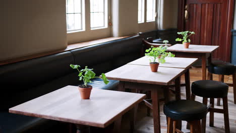 Close-Up-Of-Tables-and-Chairs-Set-For-Service-In-Empty-Restaurant