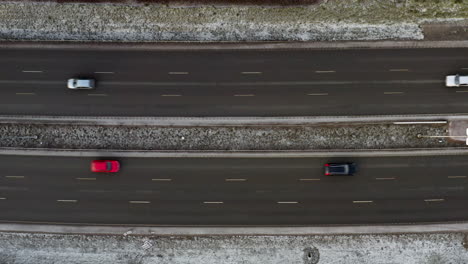 aerial, top down, drone shot, rising above cars on parallel streets, some frost on the ground, in helsinki city, on a overcast, winter day, in finland
