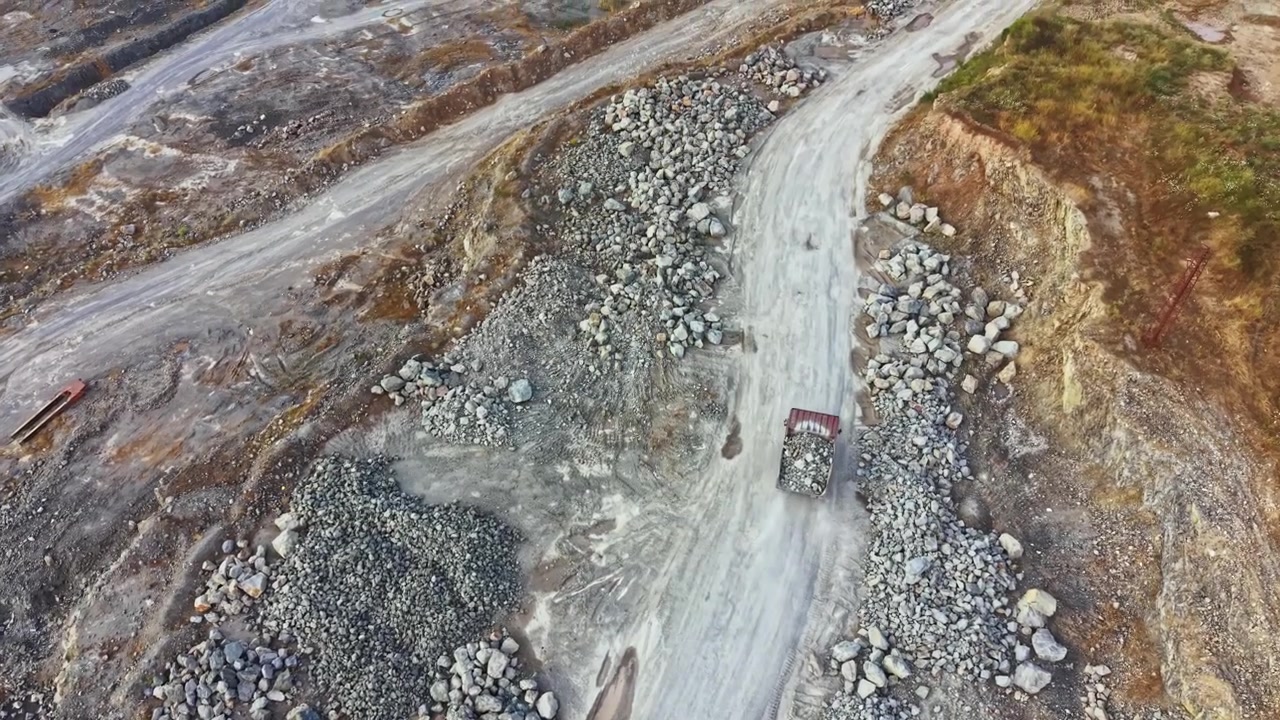 Granite quarry in operation showing equipment and materials at work during daylight