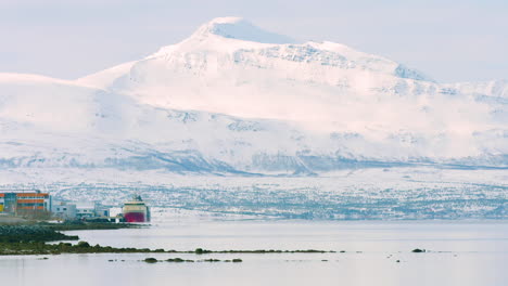 Stunning-cinematic-wide-shot-of-a-cargo-ship-being-loaded-in-Troms?